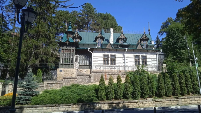 a large white house with a green roof
